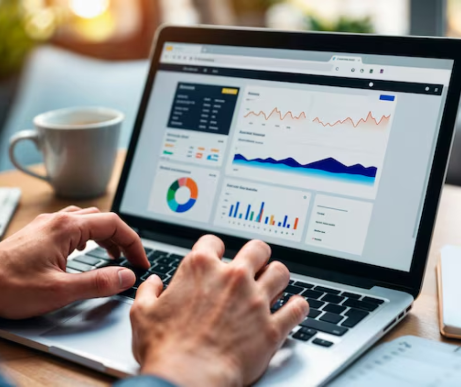 A marketing professional reviewing website analytics at a desk with a laptop and notebook.
